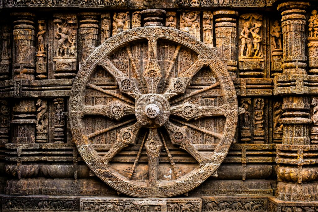 Close-up of the detailed stone engravings of the Konark Sun Temple's wheel in India.